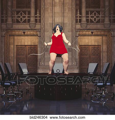 Woman standing on conference table breaking shackles View Large Photo Image Picture - Woman standing on conference table breaking shackles. Fotosearch