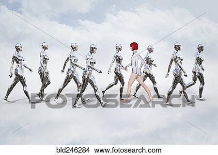 Picture - Woman walking in opposite direction of robots. Fotosearch