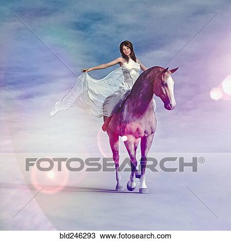 Stock Image - Woman wearing white dress riding horse. Fotosearch