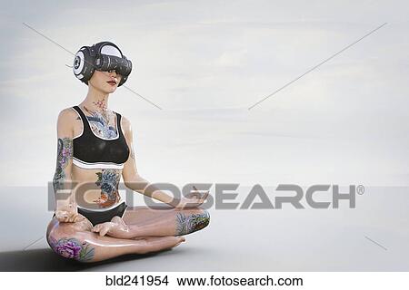 Woman with tattoos meditating and wearing virtual reality helmet View Large Photo Image Picture - Woman with tattoos meditating and wearing virtual reality helmet. Fotosearch