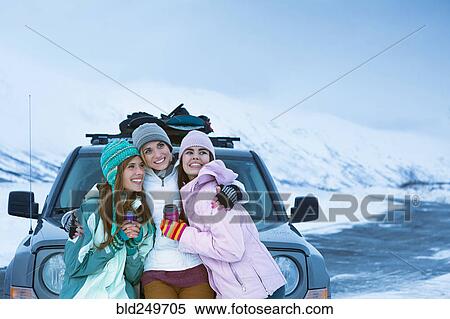 Women hugging near car in winter View Large Photo Image Stock Photography - Women hugging near car in winter. Fotosearch