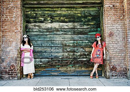 Women leaning on loading dock wearing skull face paint View Large Photo Image Stock Photograph - Women leaning on loading dock wearing skull face paint. Fotosearch