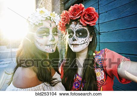 Women on sidewalk wearing skull face paint View Large Photo Image Picture - Women on sidewalk wearing skull face paint. Fotosearch