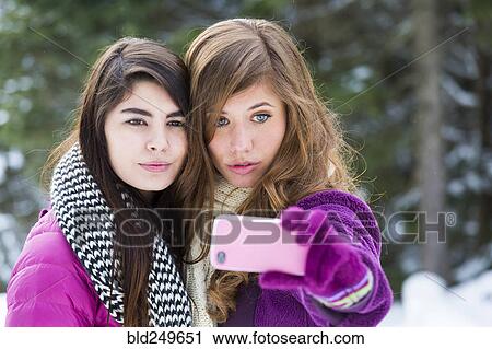 Women posing for cell phone selfie in winter View Large Photo Image Stock Image - Women posing for cell phone selfie in winter. Fotosearch