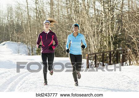 Women running on snow in winter View Large Photo Image Stock Photo - Women running on snow in winter. Fotosearch