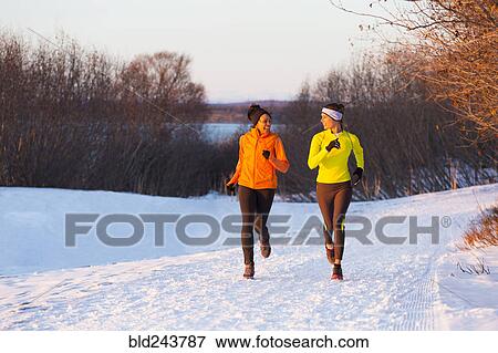 Women running on snow in winter View Large Photo Image Stock Photo - Women running on snow in winter. Fotosearch