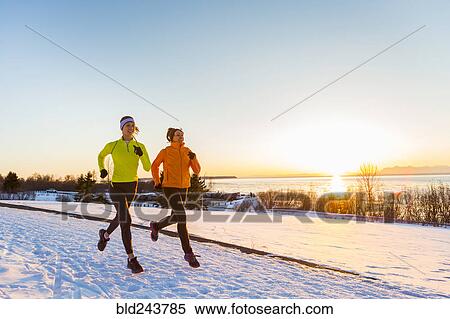 Women running on snow in winter View Large Photo Image Stock Photography - Women running on snow in winter. Fotosearch