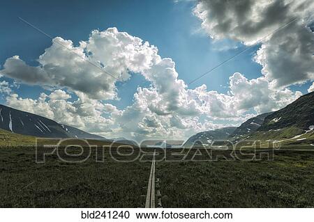 Stock Image - Wooden boardwalk in remote green valley. Fotosearch