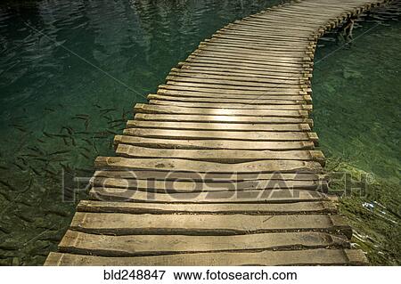 Stock Photo - Wooden footbridge over water. Fotosearch