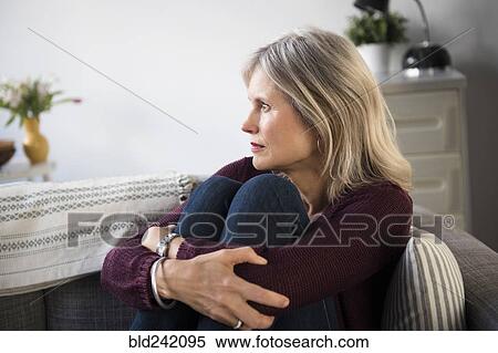 Worrying Caucasian woman hugging legs View Large Photo Image Stock Photography - Worrying Caucasian woman hugging legs. Fotosearch