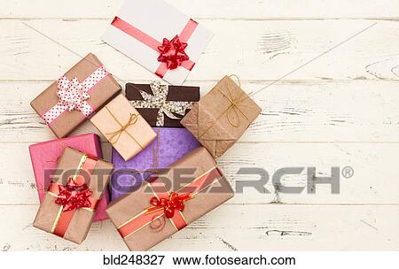 Wrapped gifts on wooden table View Large Photo Image Stock Photo - Wrapped gifts on wooden table. Fotosearch