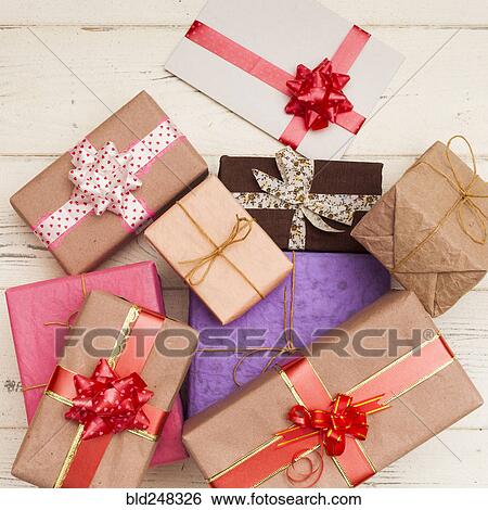 Wrapped gifts on wooden table View Large Photo Image Stock Photograph - Wrapped gifts on wooden table. Fotosearch