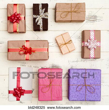 Wrapped gifts on wooden table View Large Photo Image Stock Photography - Wrapped gifts on wooden table. Fotosearch