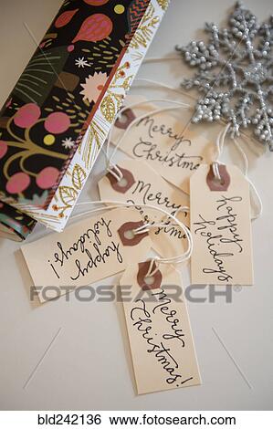 Stock Photograph - Wrapping paper, tags and Christmas ornament. Fotosearch