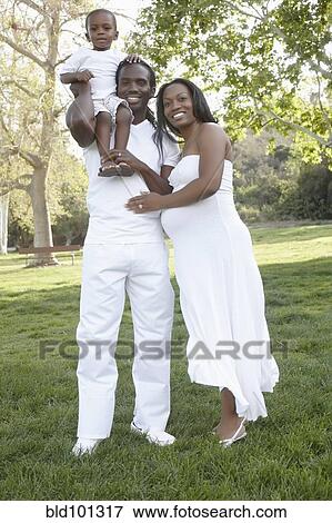 Stock Photo - African American family standing together in park. Fotosearch