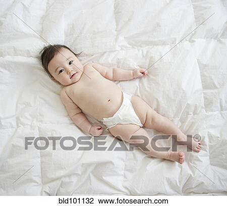 Asian baby girl laying on blanket View Large Photo Image Stock Image - Asian baby girl laying on blanket. Fotosearch