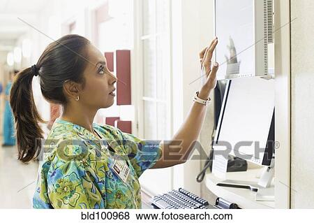 Asian nurse using equipment in hospital View Large Photo Image Stock Photo - Asian nurse using equipment in hospital. Fotosearch