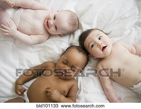 Stock Image - Babies laying on blanket. Fotosearch