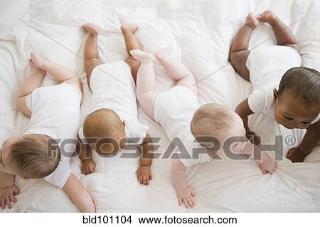 Babies laying on floor together View Large Photo Image Picture - Babies laying on floor together. Fotosearch