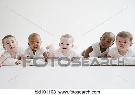 Stock Image - Babies laying on floor together. Fotosearch
