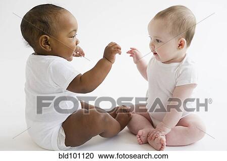 Babies playing together on floor View Large Photo Image Stock Image - Babies playing together on floor. Fotosearch