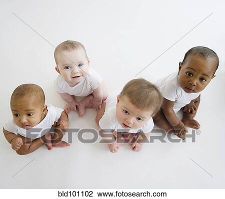 Stock Image - Babies sitting on floor. Fotosearch