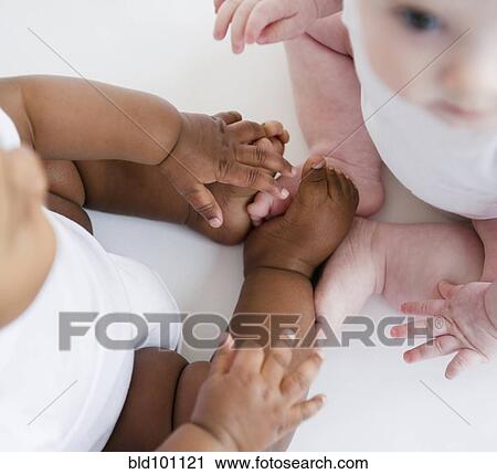 Babies sitting together on floor View Large Photo Image Stock Image - Babies sitting together on floor. Fotosearch