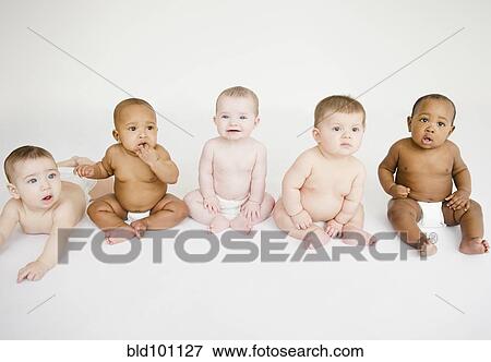 Stock Photo - Babies sitting together on floor. Fotosearch