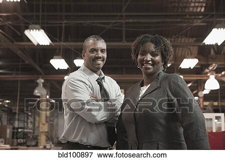 Stock Photo - Black business people standing in warehouse. Fotosearch