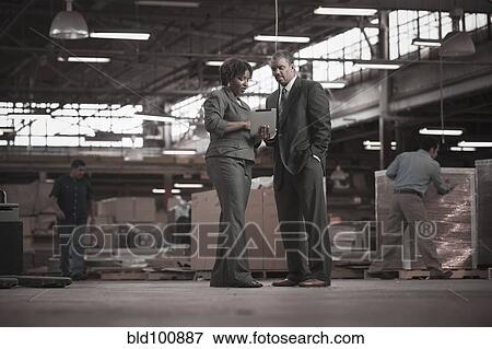 Stock Photo - Black business people working in warehouse. Fotosearch