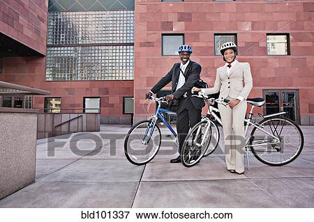 Stock Photo - Business people in courtyard with bicycles. Fotosearch