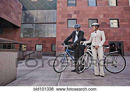 Stock Photograph - Business people in courtyard with bicycles. Fotosearch