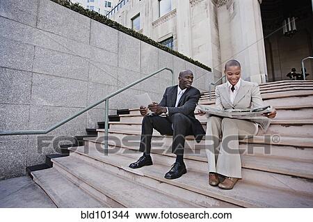 Business people unwinding on urban stairs View Large Photo Image Picture - Business people unwinding on urban stairs. Fotosearch