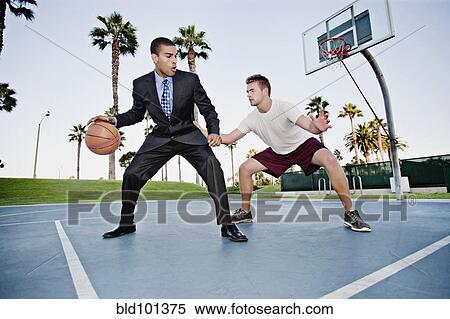 Businessman playing basketball with friend View Large Photo Image Stock Photography - Businessman playing basketball with friend. Fotosearch