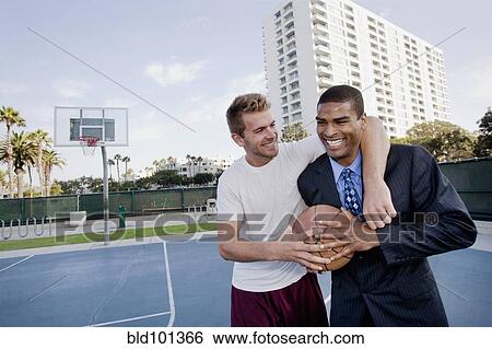 Businessman with friend on basketball court View Large Photo Image Stock Photograph - Businessman with friend on basketball court. Fotosearch