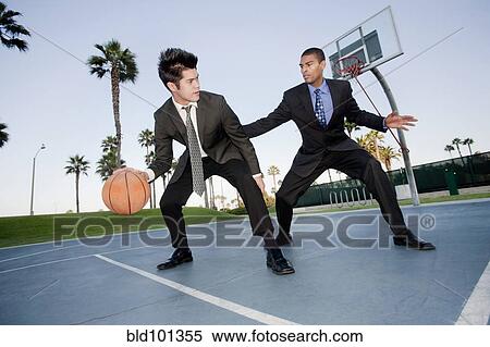 Businessmen playing basketball outdoors View Large Photo Image Stock Photography - Businessmen playing basketball outdoors. Fotosearch