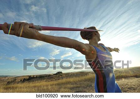 Stock Image - Caucasian athlete aiming javelin. Fotosearch