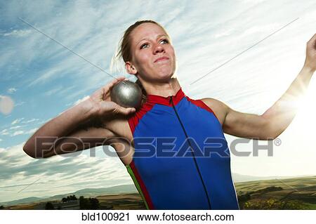 Stock Image - Caucasian athlete preparing to throw the shot put. Fotosearch