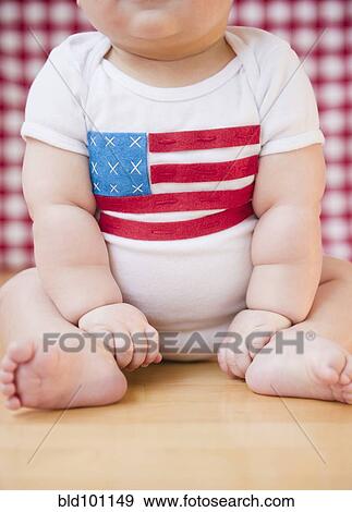 Stock Photo - Caucasian baby boy in onesie with American flag on it. Fotosearch