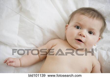 Stock Photo - Caucasian baby boy laying on blanket. Fotosearch
