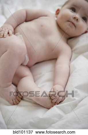 Stock Photo - Caucasian baby girl laying on blanket. Fotosearch
