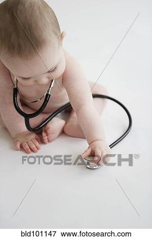 Stock Photo - Caucasian baby girl playing with stethoscope. Fotosearch