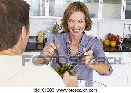 Stock Photo - Caucasian couple eating salad. Fotosearch