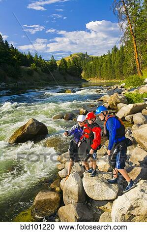 Caucasian family standing on rocks near river View Large Photo Image Stock Image - Caucasian family standing on rocks near river. Fotosearch