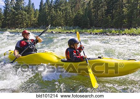 Picture - Caucasian father and son kayaking in river. Fotosearch