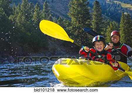 Stock Photo - Caucasian father and son kayaking on river. Fotosearch