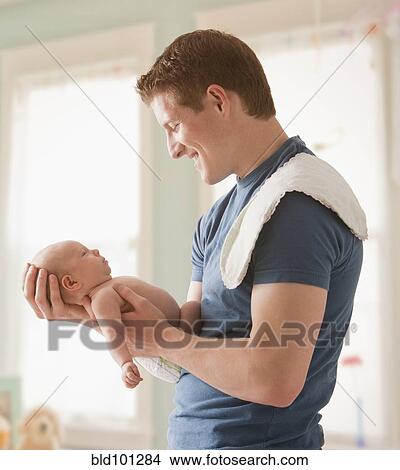 Picture - Caucasian father holding baby girl. Fotosearch