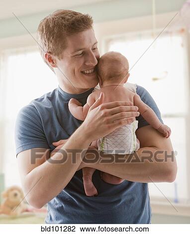 Caucasian father holding baby girl View Large Photo Image Stock Image - Caucasian father holding baby girl. Fotosearch