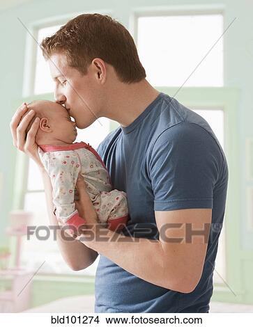 Picture - Caucasian father kissing baby girl. Fotosearch