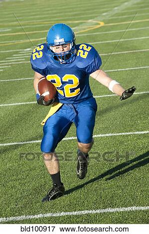 Caucasian football player running with ball View Large Photo Image Stock Photo - Caucasian football player running with ball. Fotosearch